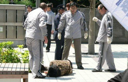 'Outrageous': Activists claim the photo above shows a student lying unconscious after being roughed up by security guards hired by Hosei University during a rally at its Ichigaya campus. | COURTESY OF ZENGAKUREN